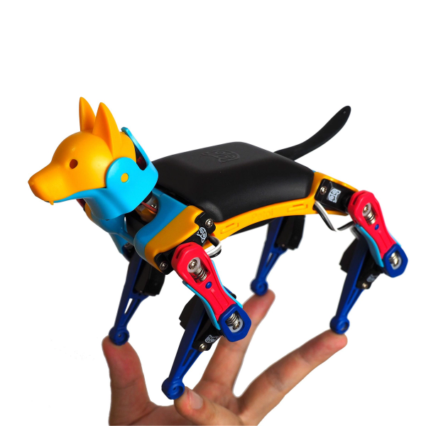 Small, colorful robotic dog is shown standing on a person's hand